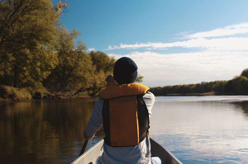 a male rowing in a canoe along the saint croix river in maine, canoeing in a river in maine 4k