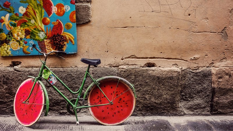 a green bicycle with wheels resembling a cross section of a watermelon, unique watermelon bicycle 4k