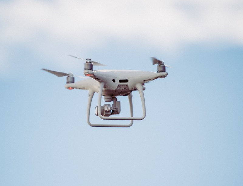 a white dji drone in the air, drone flying 4k