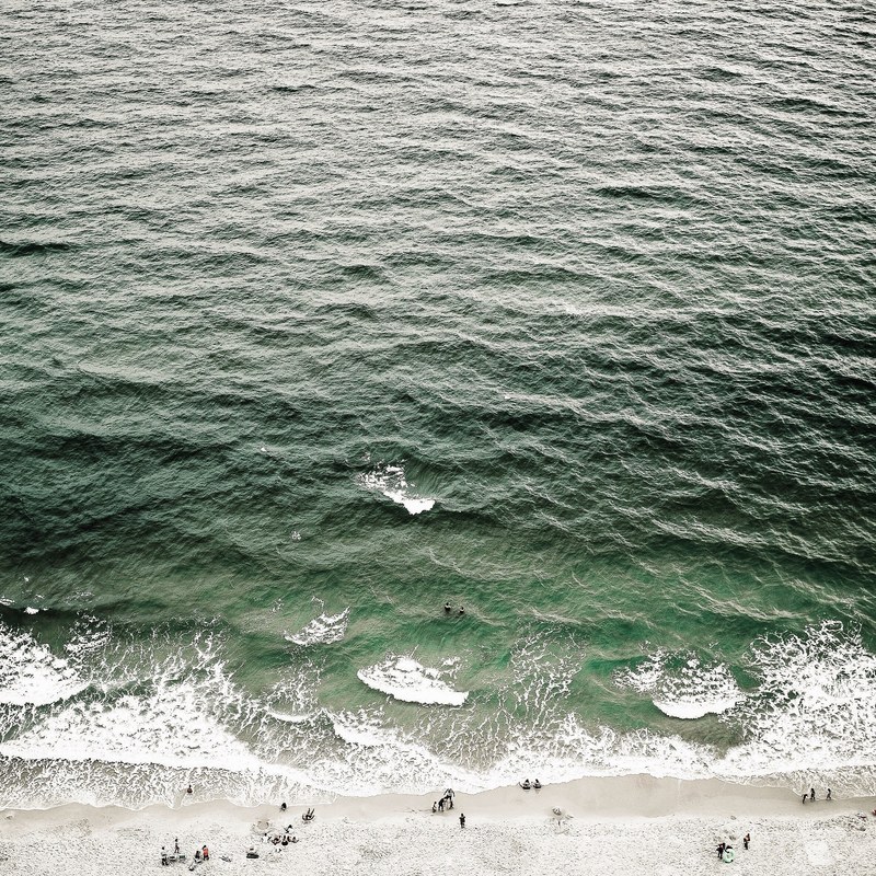 drone aerial view of the ocean waves washing on the sand gulf shores, drone view of ocean waves 4k