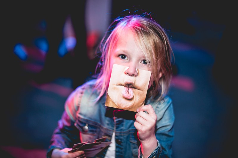 a child holds a picture of puckered lips in front of her face in sliedrecht, picture of puckered lips 4k