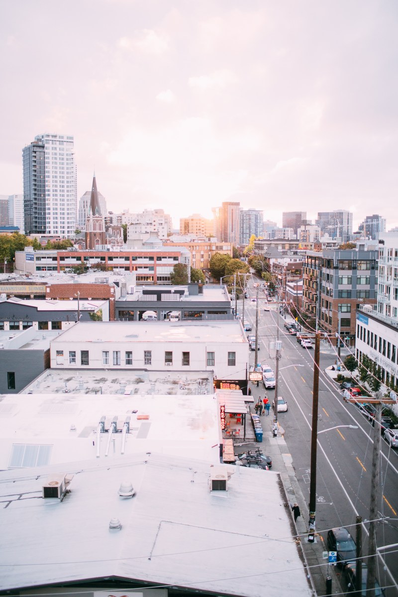 rooftop shot of capitol hill road with city buildings and skyscrapers in background, rooftop 4k