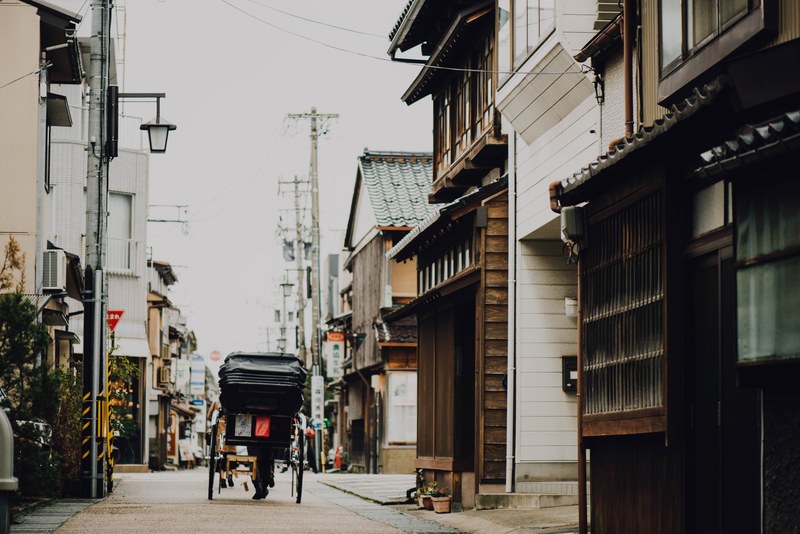 asian street with a carriage going down the road lined with buildings and power lines, asian street and carriage 4k