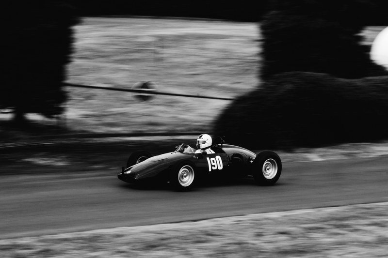 black and white of small race car speeding on track, small race car on track 4k