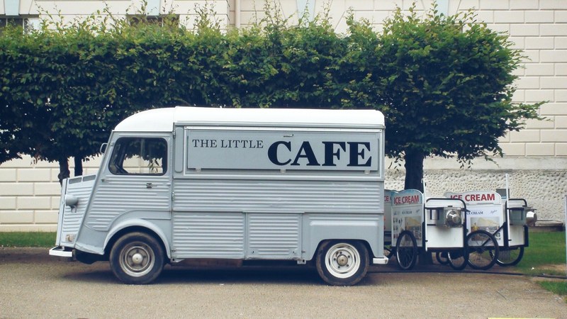 a food truck parked next to ice cream carts, food truck and ice cream carts 4k