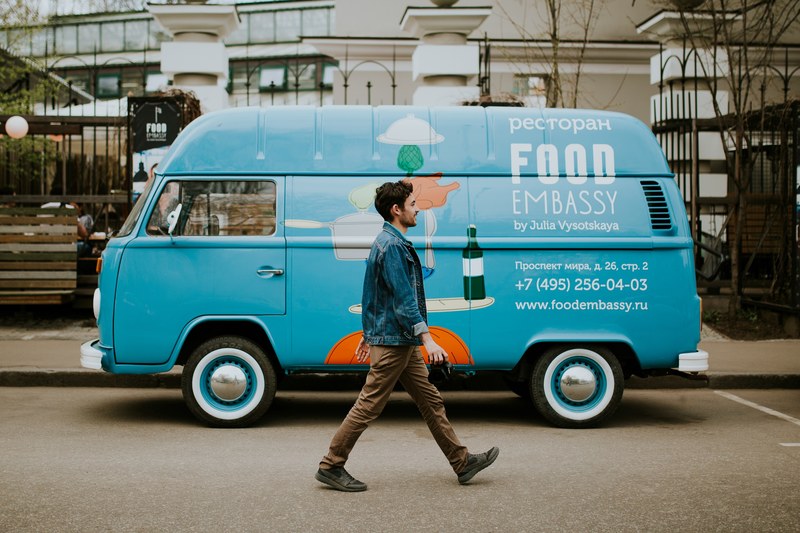 a man in a denim jacket walking past a restaurant van, walk my dreams 4k