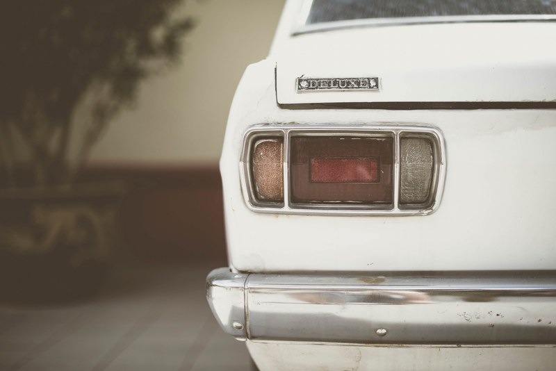 back view of the one tail light and chrome bumper of the old vintage car, old vintage car tail light and bumper 4k