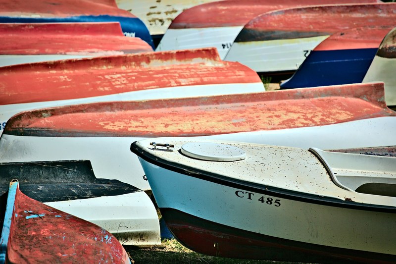 a number of boats flipped upside down on a shore, upside down boats 4k