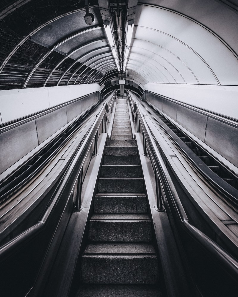 an empty staircase and two escalators in a tunnel in london, tunnel stairs 4k