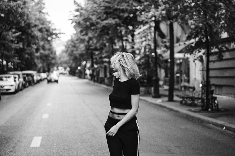 a woman wearing all black walking down the street in paris, all the pretty girls 4k