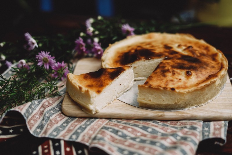 slice of homemade cheesecake on a rustic tablescape with rosemary flowers, cheesecake for dessert 4k
