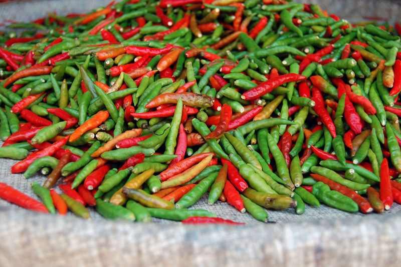 red and green chili peppers gathered in a cloth, green red hot 4k