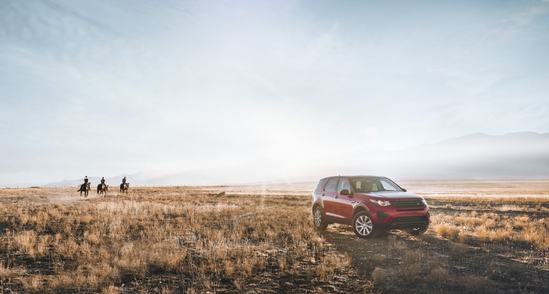 a bright shot of an off road vehicle parked on a prairie with three horse riders in the distance, suv and cowboys on a sunny afternoon 4k