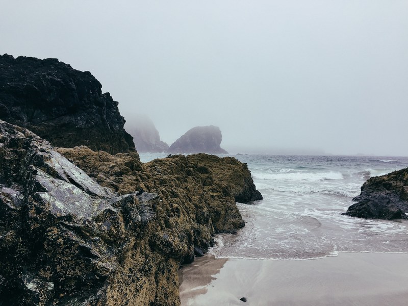 coastal rock cliffs by the rough sea in cornwall, fog on the seaside 4k