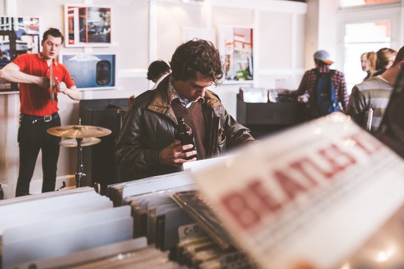 young people browsing the vinyls at a record score, vintage record store 4k