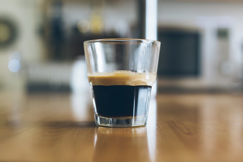 the macro view of a glass cup containing beverage drink, glass cup of beverage 4k
