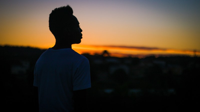 silhouette of a person standing alone at sunset, nothing 4k
