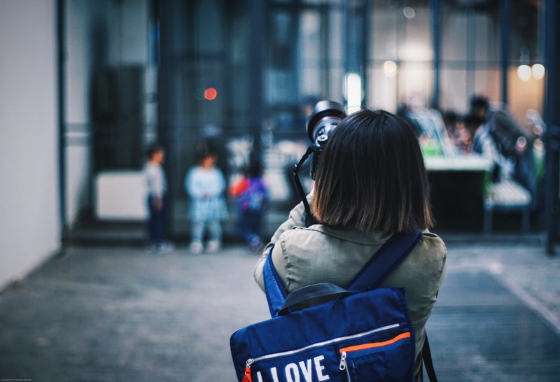 young girl taking photograph with i love bag with people in background beijing 798 art district, 789 art museum 4k