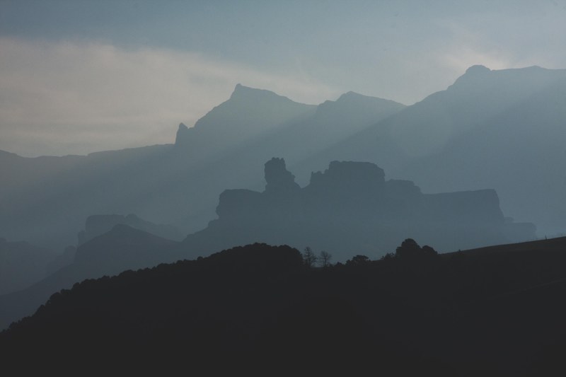 clouds and mist cover mountains, foggy silhouettes 4k