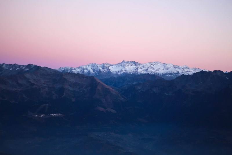 a beautiful landscape with a snowy mountain ridge crowning the horizon, snowy mountain 4k