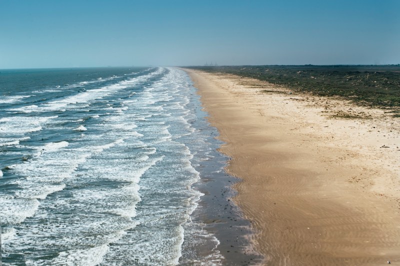 ocean waves washing on a barren shore at port aransas, the gulf coast 4k