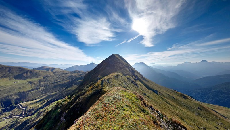 view from a grassy ridge on a green mountainous landscape near monte lodin, green monte lodin landscape 4k