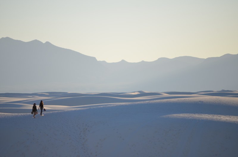 two people hike through dunes in white sands national monument, hike to the horizon 4k