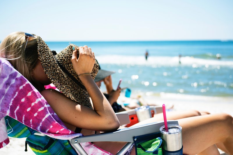 summer shot of a woman at the beach with a sunglass and a rafia hat at panama city beach, woman with sunglasses and hat at panama city beach 4k
