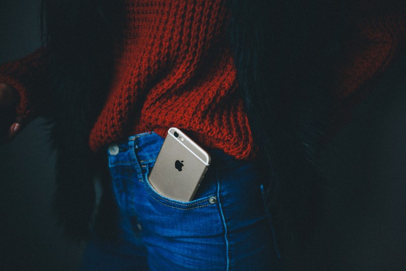 an iphone sticking out of a pocket in a persons jeans, iphone in a jeans pocket 4k
