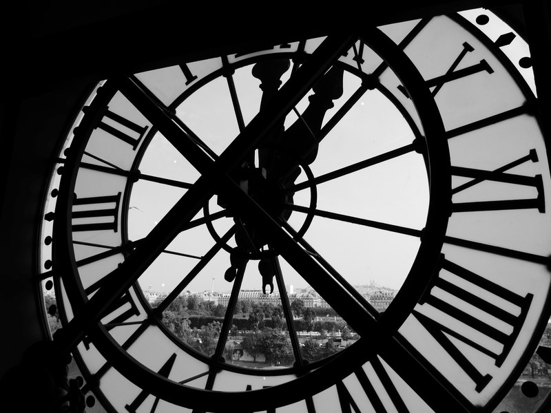 a black and white shot from behind a clock looking out into paris, behind a clock 4k