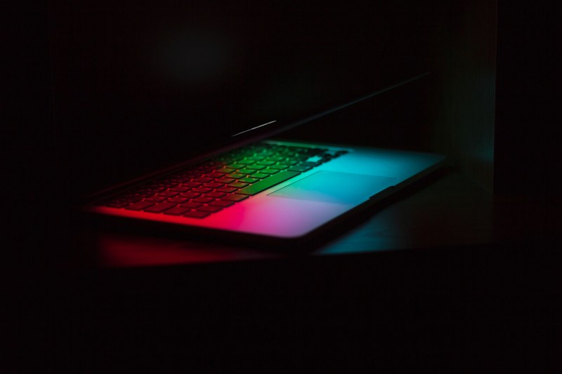 a macbook computer on a table with a rainbow screensaver in nizhny novgorod, nizhny novgorod macbook 4k