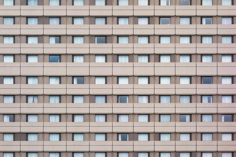 the tokyo metropolitan government building with brown walls and symmetrical windows on each floor, _tokyo tocho building 4k