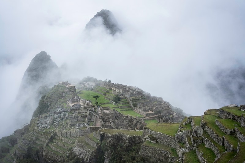 fog setting over the machu picchu ruins on a cool day, misty machu picchu 4k