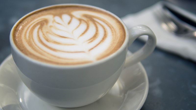 close up of a cup of cappuccino with latte art, latte art on cappuccino 4k
