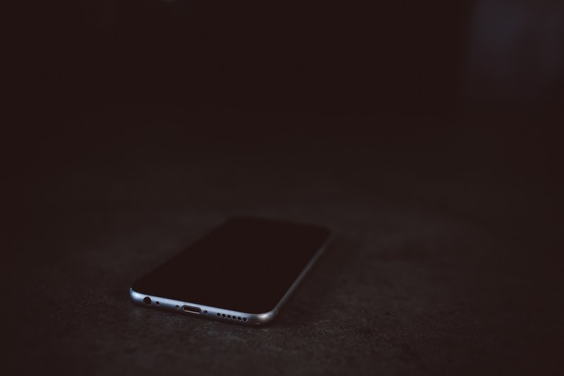 an iphone cellphone on a black surface, iphone cellphone 4k