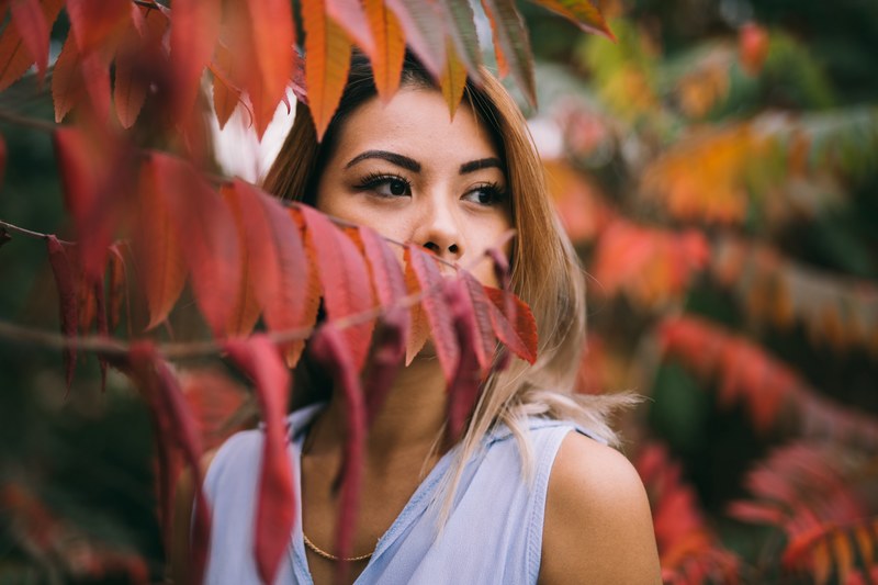 young woman enjoys fall weather with red leaves 4k