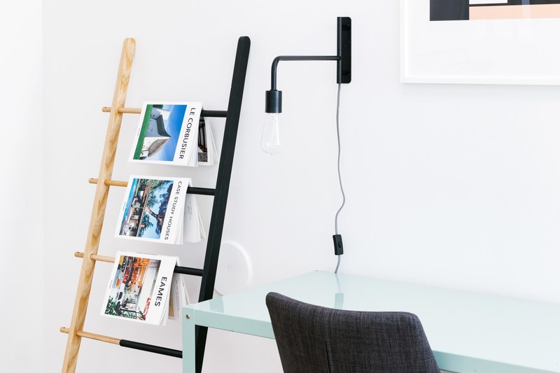magazines on architecture hanging from a ladder in a minimal interior, minimalist office decor at 1540 7th st 4k