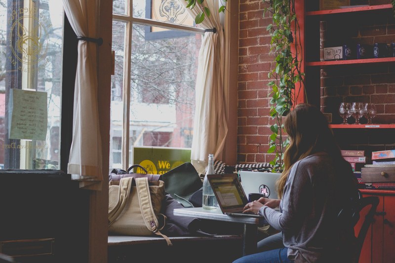 a lady working on her laptop at five eyed fox, working at five eyed fox 4k