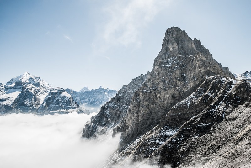 the snow covered bunderspitz mountain peak rising above the clouds, bunderspitz mountain above clouds 4k