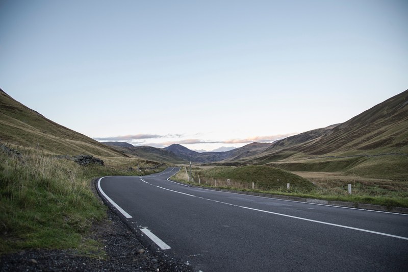 a mountain road through cairngorms national park hills, cairngorms national park road 4k