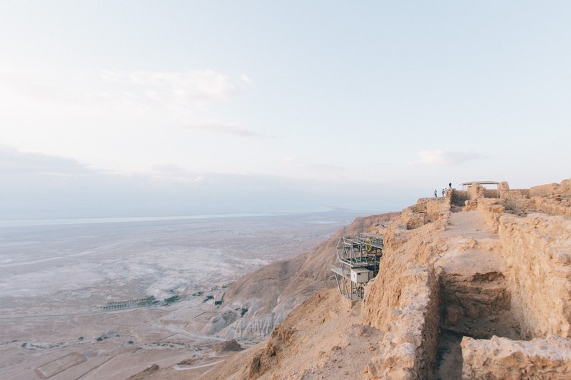 industrial structures in the desert mountainside of masada national park, desert tours 4k