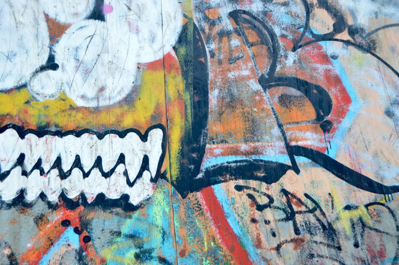 colorful urban spray painted street art graffiti design on wall weathered by urban decay n8, wooded trail with urban art 4k