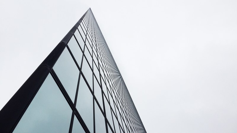 an angular shot of a tall glass facade in boston, tall building and dark lines 4k