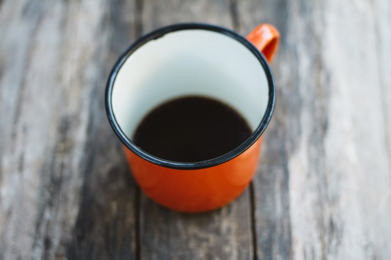 nice cup of coffee in a red mug on the road 4k