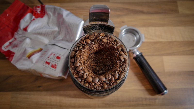 coffee grinder full of beans and grounds, half ground 4k