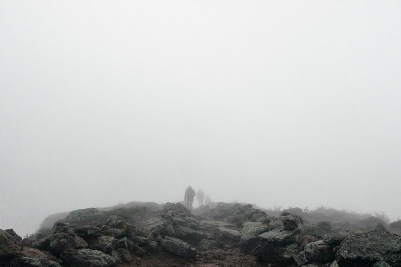 hikers disappear into the fog on a rocky mountain hike, rocky hike 4k
