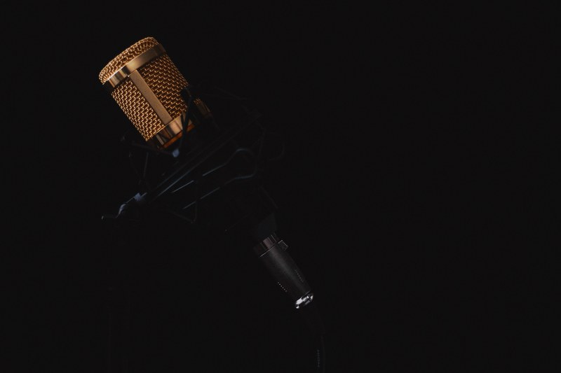 a professional microphone against a black background, darkness of speech 4k