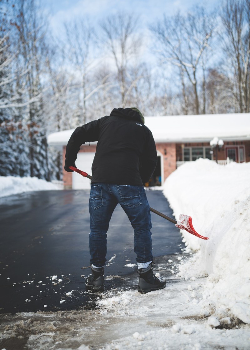 a man shoveling snow off his driveway in muskoka, shovelling 4k