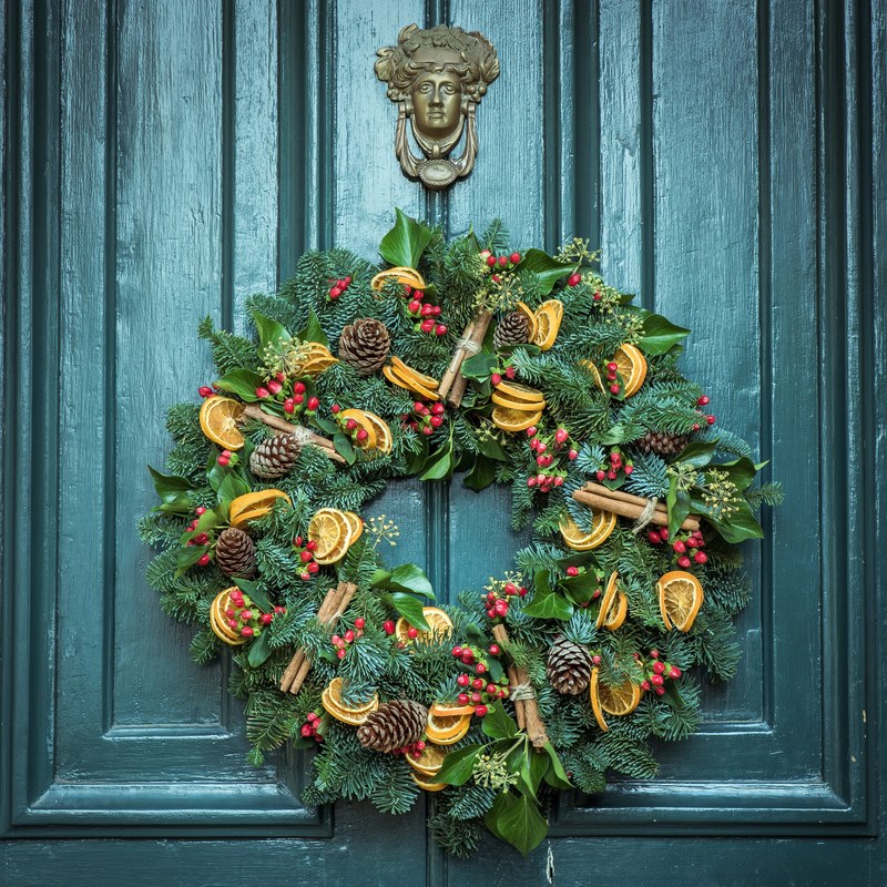 a festive fall foliage wreath hangs on a dark green door, fall foliage wreath on door 4k