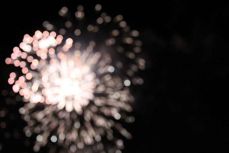 out of focus firework in mid explosion at night, happy new year 4k